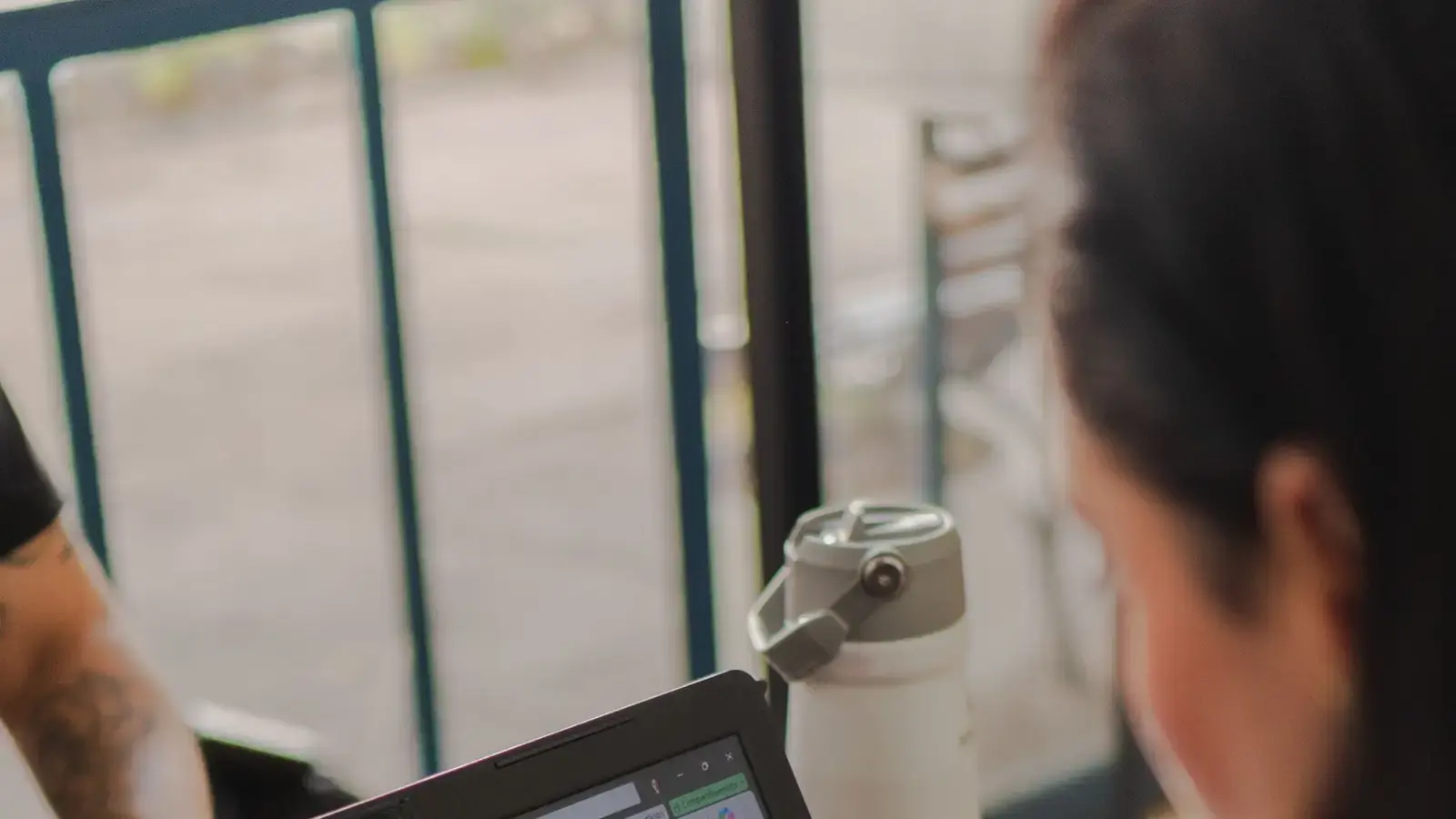 A person reviewing a spreadsheet on a laptop