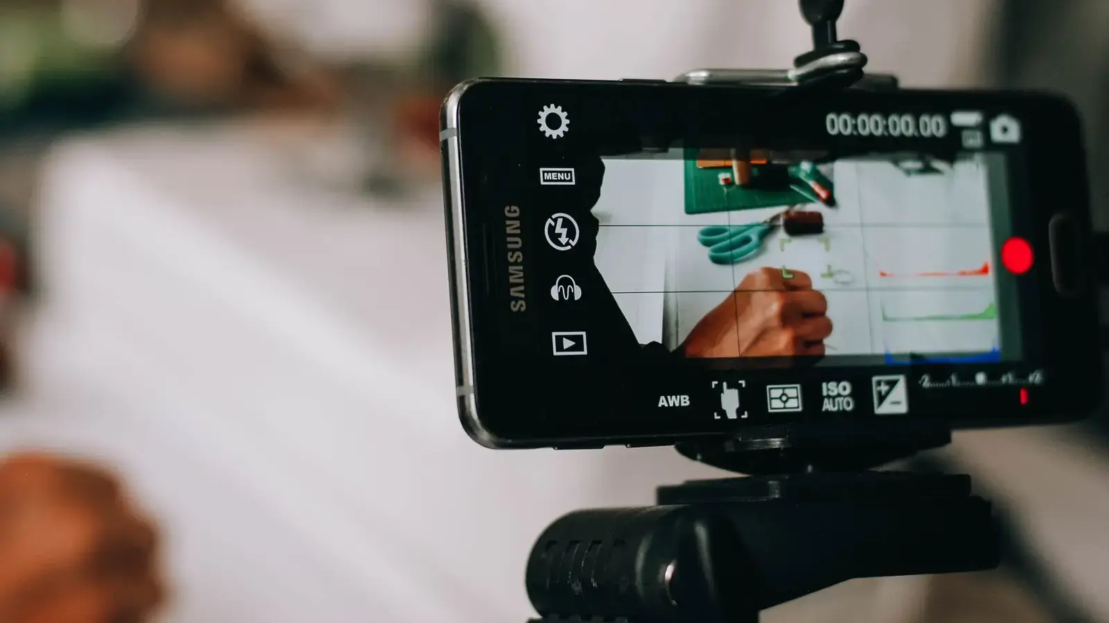 A smartphone on a tripod recording a video